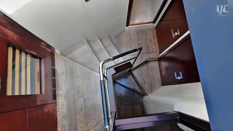 Phantom Yacht Photos Pics Staircase inside 2011 Sunseeker Manhattan 63 yacht, featuring wooden steps and modern design.