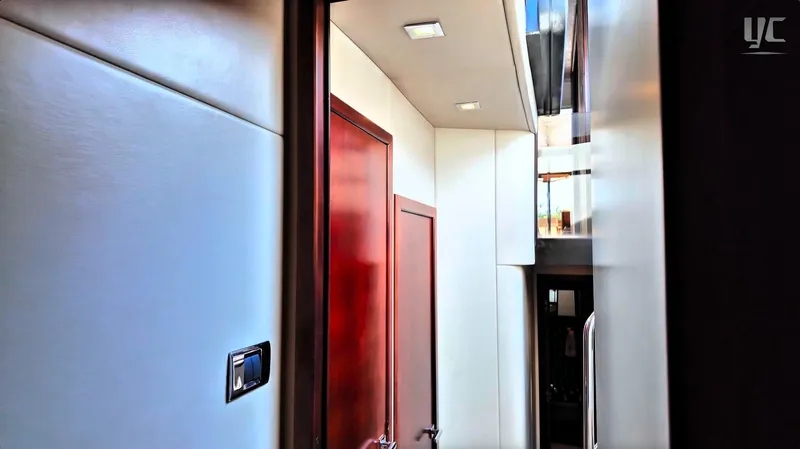 Phantom Yacht Photos Pics Interior hallway of 2011 Sunseeker Manhattan 63 yacht, featuring sleek design and wooden doors.