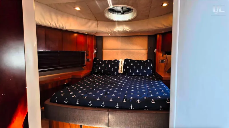 Phantom Yacht Photos Pics Luxurious cabin interior of 2011 Sunseeker Manhattan 63 yacht with nautical-themed bedding.