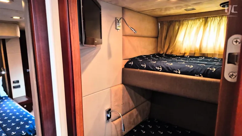 Phantom Yacht Photos Pics Luxurious cabin interior of 2011 Sunseeker Manhattan 63 yacht with cozy bedding and TV.