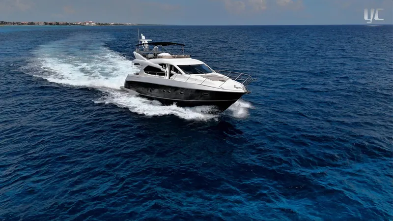 Phantom Yacht Photos Pics 2011 Sunseeker Manhattan 63 yacht cruising on open blue sea.