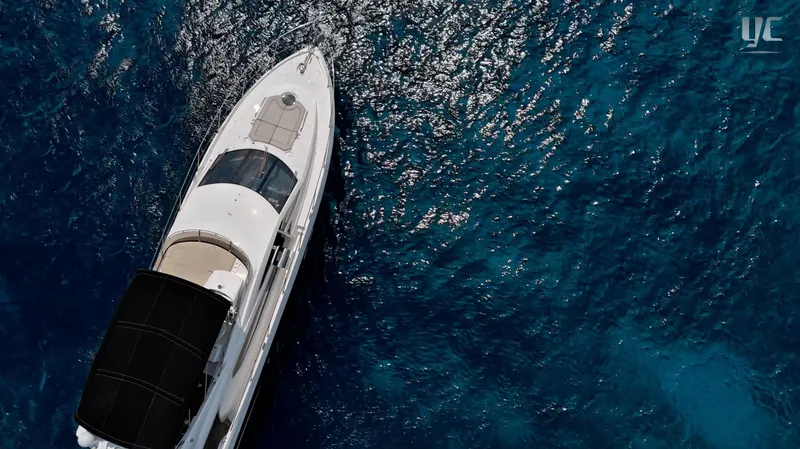 Phantom Yacht Photos Pics Aerial view of 2011 Sunseeker Manhattan 63 yacht on sparkling blue water.