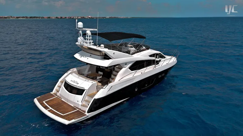 Phantom Yacht Photos Pics Luxurious 2011 Sunseeker Manhattan 63 yacht cruising on open blue sea.