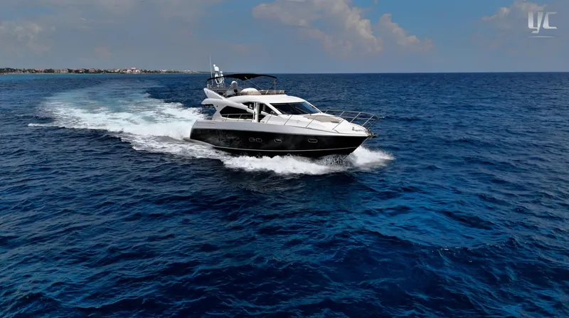 Phantom Yacht Photos Pics 2011 Sunseeker Manhattan 63 yacht cruising on open blue sea.