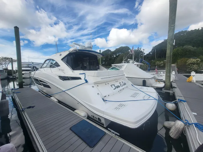 Tam- E- Lee Yacht Photos Pics 2013 Sea Ray 510 Sundancer yacht docked at marina under blue sky.