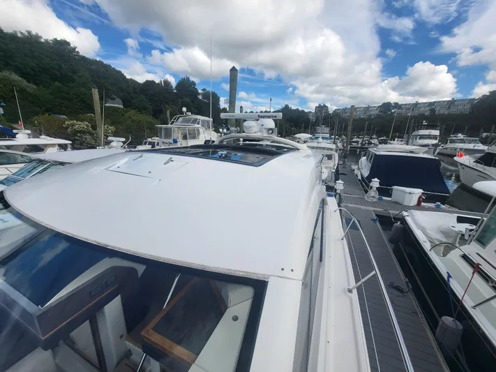 Tam- E- Lee Yacht Photos Pics 2013 Sea Ray 510 Sundancer yacht docked at marina under cloudy sky.