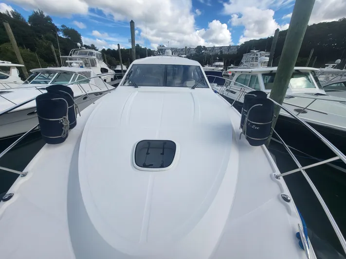 Tam- E- Lee Yacht Photos Pics 2013 Sea Ray 510 Sundancer yacht docked among other boats under a cloudy sky.