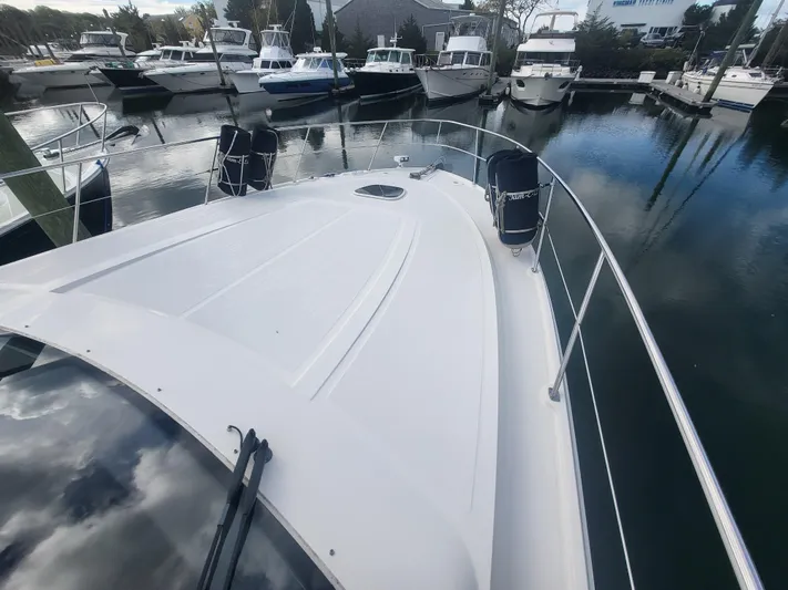 Tam- E- Lee Yacht Photos Pics 2013 Sea Ray 510 Sundancer yacht docked in a marina, surrounded by other boats.