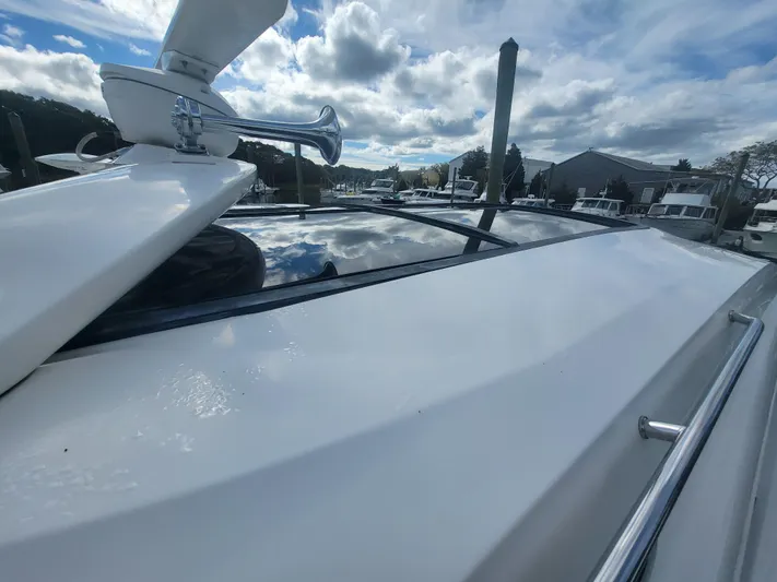 Tam- E- Lee Yacht Photos Pics 2013 Sea Ray 510 Sundancer yacht, sleek design, docked under cloudy sky.