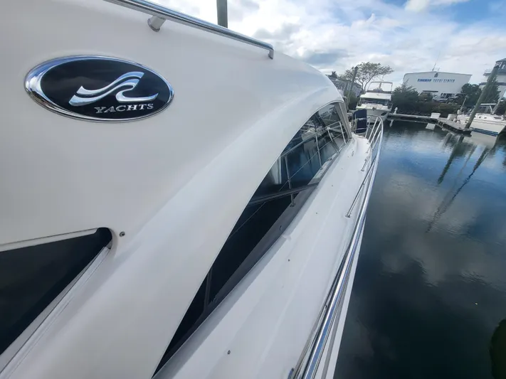 Tam- E- Lee Yacht Photos Pics 2013 Sea Ray 510 Sundancer yacht docked, showcasing sleek design and reflective water surface.