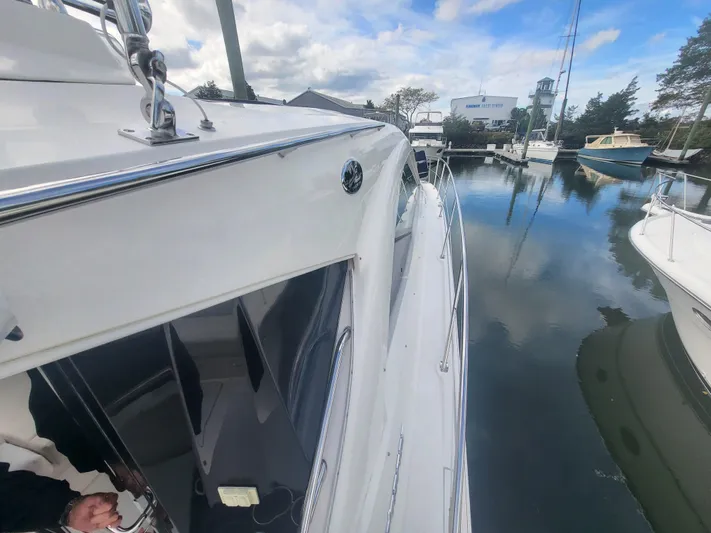 Tam- E- Lee Yacht Photos Pics 2013 Sea Ray 510 Sundancer docked in a marina, reflecting on calm water.
