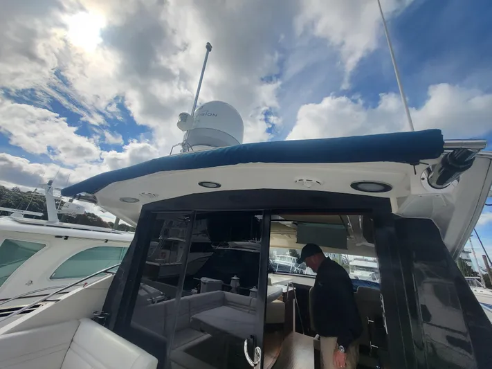 Tam- E- Lee Yacht Photos Pics 2013 Sea Ray 510 Sundancer yacht with a person onboard, under a partly cloudy sky.