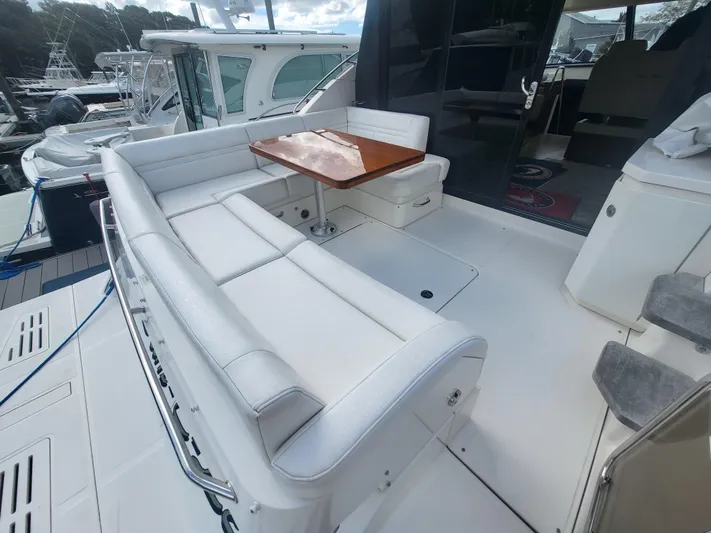 Tam- E- Lee Yacht Photos Pics 2013 Sea Ray 510 Sundancer yacht with white seating and wooden table on deck.