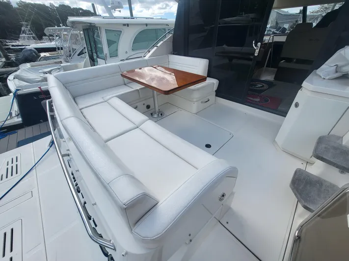 Tam- E- Lee Yacht Photos Pics 2013 Sea Ray 510 Sundancer yacht with spacious outdoor seating and wooden table.