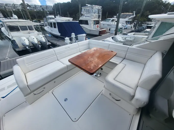 Tam- E- Lee Yacht Photos Pics 2013 Sea Ray 510 Sundancer yacht with white seating and wooden table at marina.