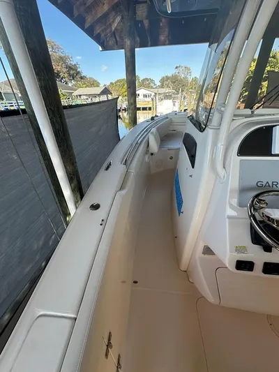  Yacht Photos Pics 2020 Grady-White Canyon 306 boat interior with steering console and dock view.