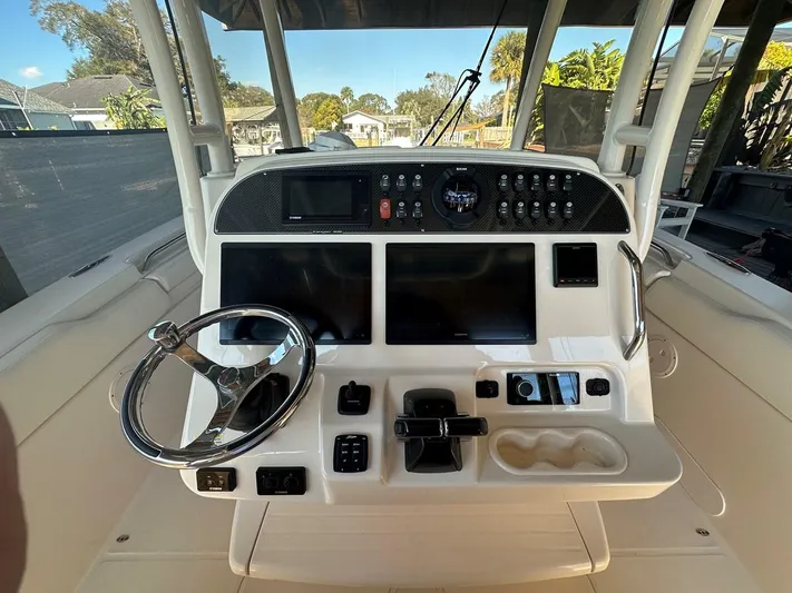  Yacht Photos Pics Cockpit of 2020 Grady-White Canyon 306 boat with steering wheel and control panel.