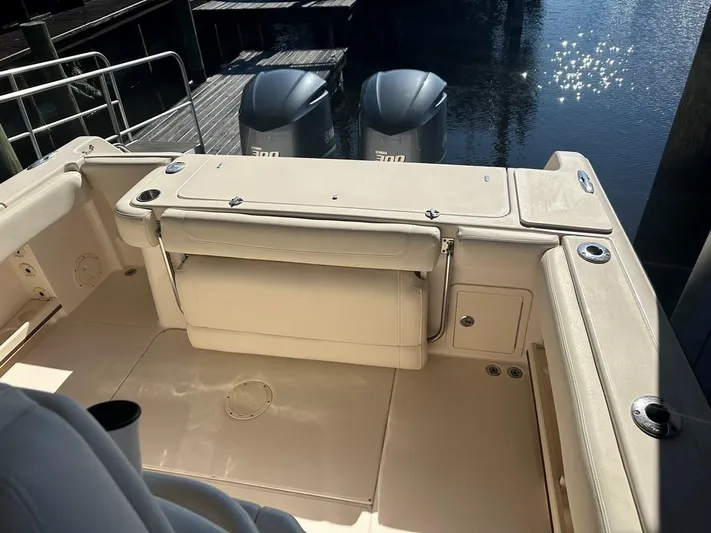  Yacht Photos Pics 2020 Grady-White Canyon 306 boat interior with dual outboard motors at dock.