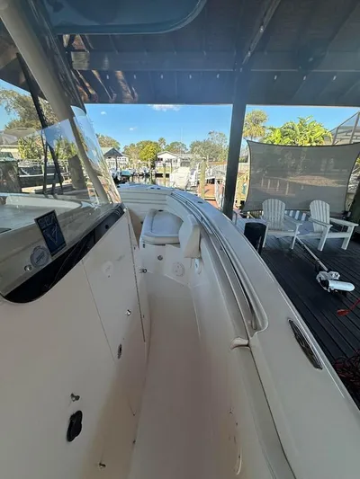  Yacht Photos Pics 2020 Grady-White Canyon 306 boat docked, showcasing sleek design and spacious deck area.