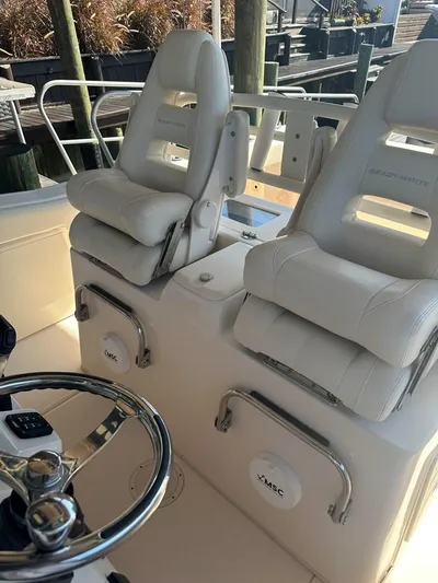  Yacht Photos Pics 2020 Grady-White Canyon 306 boat interior with dual white captain's chairs and steering wheel.