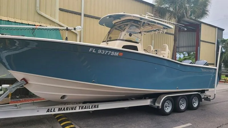  Yacht Photos Pics 2020 Grady-White Canyon 306 boat on trailer, blue hull, parked outdoors.