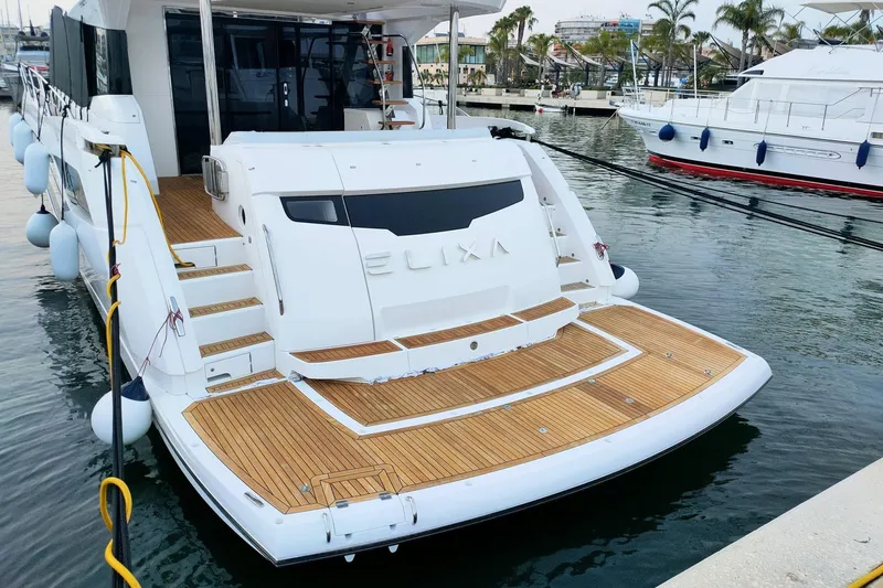 Elixa Yacht Photos Pics 2022 Sunseeker Manhattan 68 yacht docked, featuring elegant teak decking and modern design.