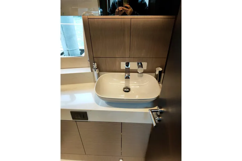 Elixa Yacht Photos Pics Modern bathroom sink in 2022 Sunseeker Manhattan 68 yacht, featuring sleek design and fixtures.