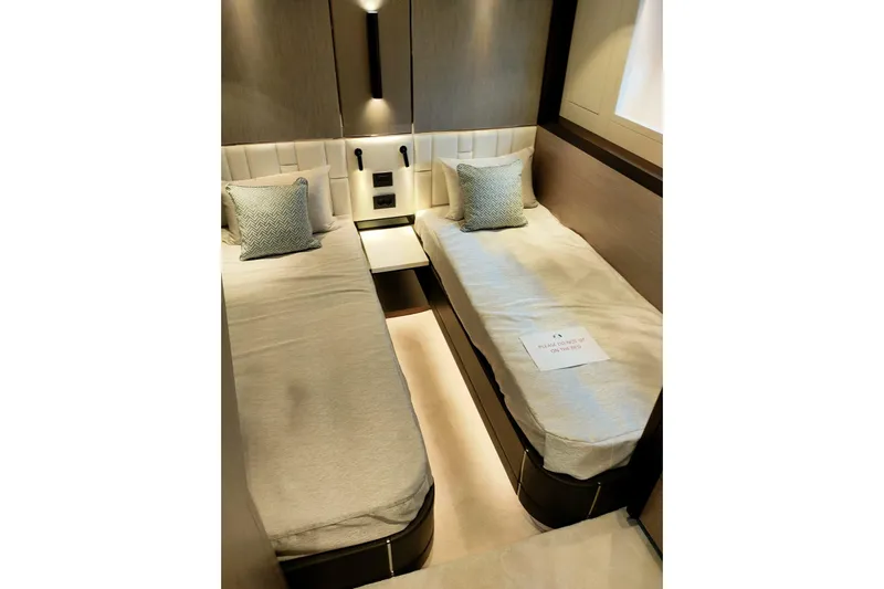 Elixa Yacht Photos Pics Luxurious twin cabin in 2022 Sunseeker Manhattan 68 yacht, featuring modern design and cozy bedding.