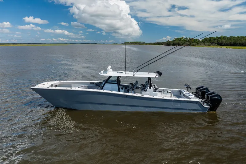  Yacht Photos Pics 2023 Freeman 47 boat on calm water under a partly cloudy sky.