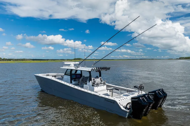  Yacht Photos Pics 2023 Freeman 47 boat on water with clear blue sky and clouds.