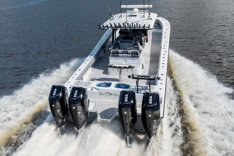  Yacht Photos Pics 2023 Freeman 47 boat with four powerful engines cruising on water.