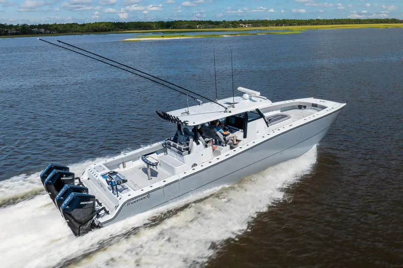  Yacht Photos Pics 2023 Freeman 47 boat cruising on a lake with powerful engines and sleek design.