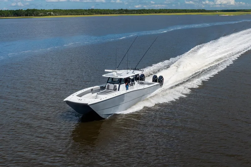  Yacht Photos Pics 2023 Freeman 47 boat cruising on open water, leaving a wake behind.