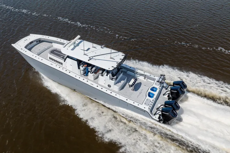  Yacht Photos Pics 2023 Freeman 47 boat cruising on water, featuring powerful outboard engines.