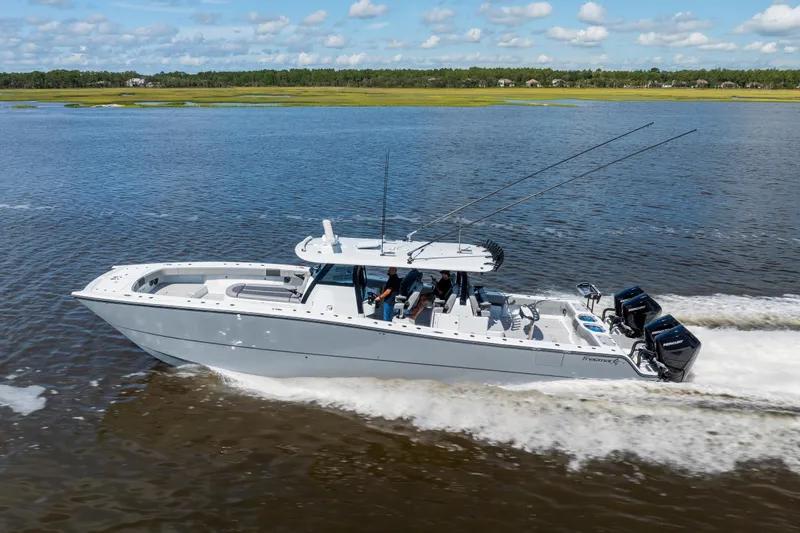  Yacht Photos Pics 2023 Freeman 47 boat cruising on a calm river under a blue sky.