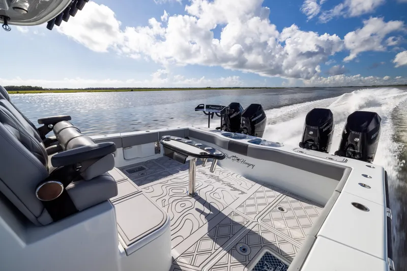  Yacht Photos Pics 2023 Freeman 47 boat cruising on water, featuring luxurious seating and powerful engines.