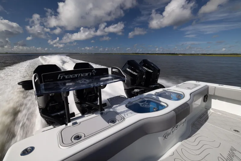  Yacht Photos Pics 2023 Freeman 47 boat with dual Mercury engines cruising on open water.