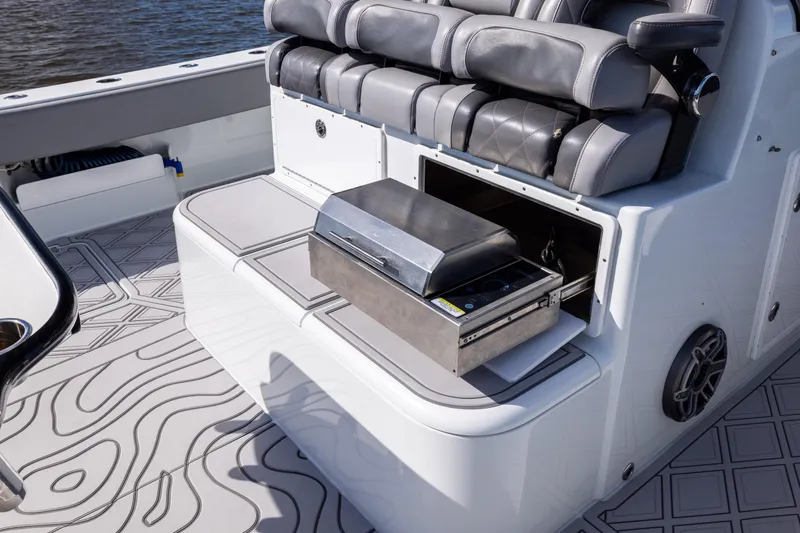  Yacht Photos Pics Luxury seating and grill setup on 2023 Freeman 47 boat, featuring sleek design and functionality.