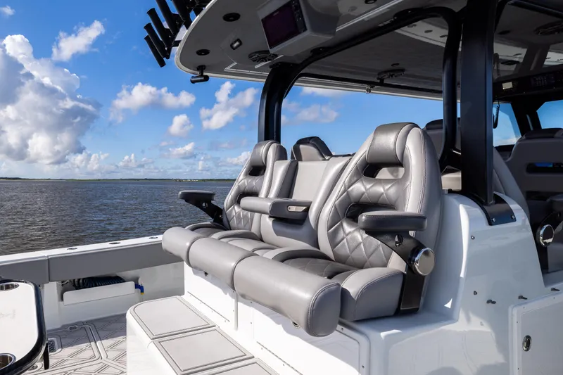  Yacht Photos Pics Luxurious seating on a 2023 Freeman 47 boat, with ocean view and blue sky.