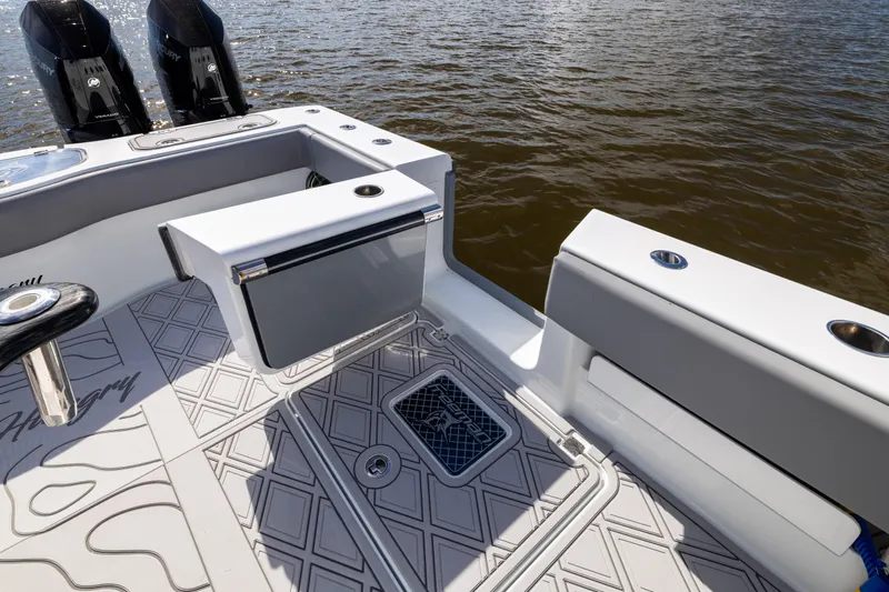  Yacht Photos Pics 2023 Freeman 47 boat deck with seating and storage, featuring dual Mercury engines.