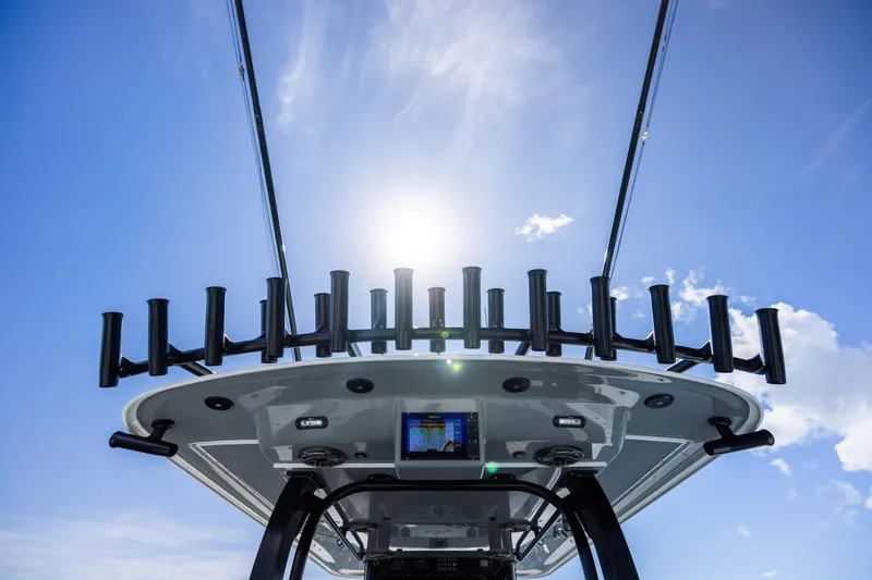  Yacht Photos Pics 2023 Freeman 47 boat with rod holders, under a clear blue sky.