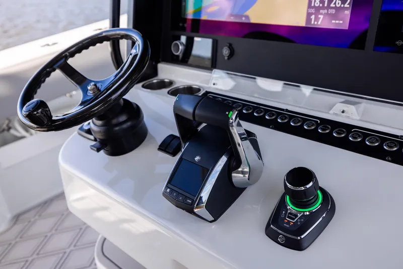  Yacht Photos Pics Control panel of 2023 Freeman 47 boat with steering wheel and navigation controls.