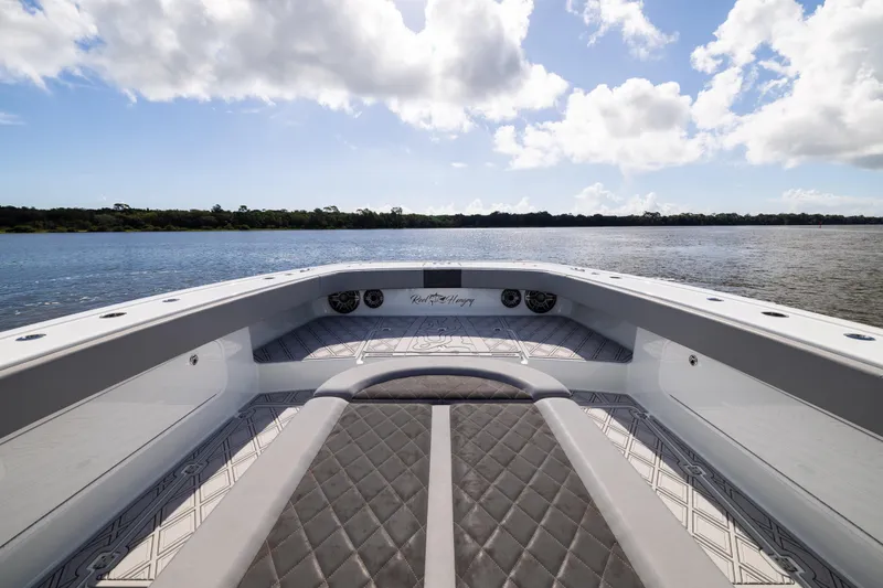  Yacht Photos Pics 2023 Freeman 47 boat interior with quilted seating, overlooking serene water and sky.