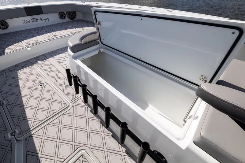  Yacht Photos Pics 2023 Freeman 47 boat with open storage compartment and rod holders on deck.