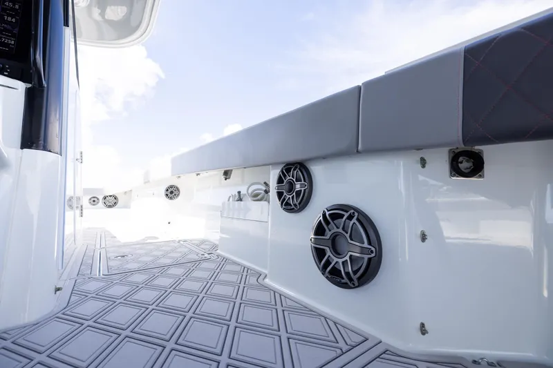  Yacht Photos Pics 2023 Freeman 47 boat interior with speakers and cushioned seating.