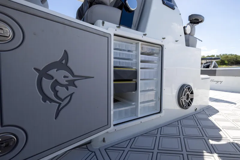  Yacht Photos Pics 2023 Freeman 47 boat with open storage compartment and marlin logo.