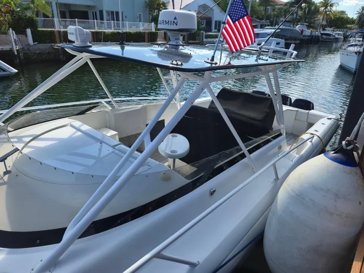  Yacht Photos Pics 2002 Intrepid 377 Walkaround boat docked, featuring sleek design and American flag.