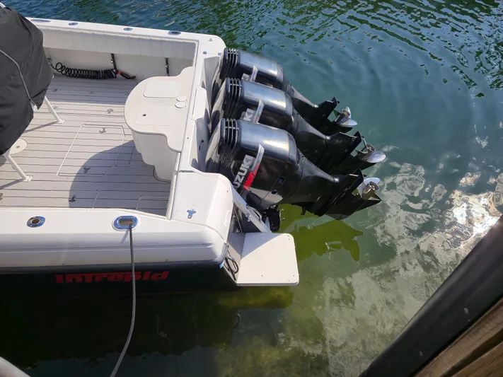  Yacht Photos Pics 2002 Intrepid 377 Walkaround boat with triple outboard engines in water.