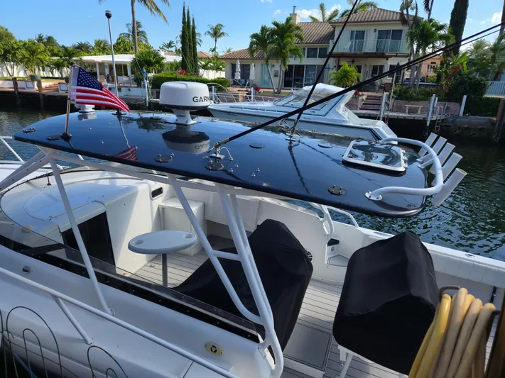  Yacht Photos Pics 2002 Intrepid 377 Walkaround boat docked, featuring sleek design and American flag.