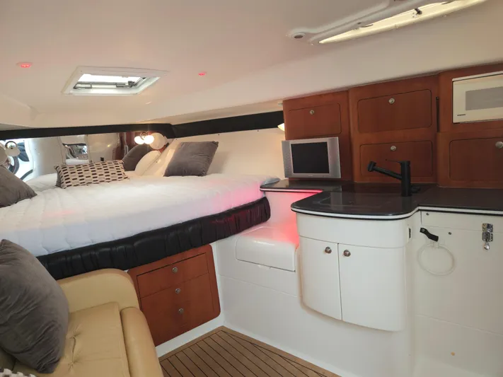  Yacht Photos Pics Interior of a 2002 Intrepid 377 Walkaround boat with cozy bed and kitchenette.